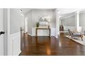 Elegant foyer features hardwood floors, neutral paint, wainscoting, and a decorative console table with stylish accents at 5060 Winship Ct, Alpharetta, GA 30009