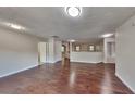 Hardwood floor living area with neutral walls and views to multiple rooms in the house at 514 Jadetree Ln, Atlanta, GA 30349