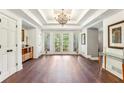 Bright and spacious foyer with hardwood floors and detailed ceiling design at 5860 Riverwood Dr, Sandy Springs, GA 30328