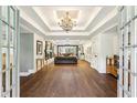 Elegant living room with hardwood floors, tray ceilings, and an open view to the backyard at 5860 Riverwood Dr, Sandy Springs, GA 30328