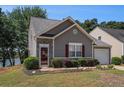 Cozy home featuring stone accents around the front door, and a well-manicured lawn at 855 Lakeside Cir, Covington, GA 30016