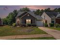 Charming one-story home with stone accents, well-maintained lawn, and attached garage at 855 Lakeside Cir, Covington, GA 30016