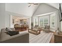 Bright living room with large windows, vaulted ceilings, and a cozy seating arrangement at 402 Lake Point Trce, Canton, GA 30114