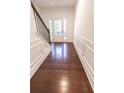 Foyer featuring dark wood floors, white walls with raised paneling and a staircase at 4305 Huron Dr, Cumming, GA 30028
