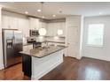 Modern kitchen featuring stainless steel appliances, granite countertops, and a center island at 4305 Huron Dr, Cumming, GA 30028