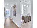 Modern bathroom with vanity, illuminated mirror, and wood-like tile flooring at 775 Juniper Ne St # 327, Atlanta, GA 30308