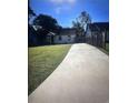 Expansive backyard showcasing a long driveway, surrounded by lush greenery and a well-maintained lawn, perfect for outdoor activities at 1132 Se Oak Knoll Se Ter, Atlanta, GA 30315