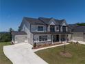 Beautiful home showcasing a three-car garage, a long driveway, and manicured landscaping at 2996 Treeside Ter, Marietta, GA 30066