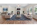 Bright and airy living room featuring a cozy fireplace, hardwood floors, and neutral decor at 3390 Meadow Grass Drive, Dacula, GA 30019