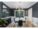 Stylish dining room with modern lighting, dark walls, and sliding glass doors at 46 Ivy Ne Rdg, Atlanta, GA 30342