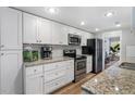 Bright kitchen featuring white cabinets, stainless steel appliances, and granite countertops at 46 Ivy Ne Rdg, Atlanta, GA 30342