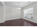 Dining room featuring hardwood floors and a hanging light fixture at 55 Clubhouse Way, Acworth, GA 30101