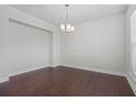 Dining room featuring hardwood floors and a hanging light fixture at 55 Clubhouse Way, Acworth, GA 30101