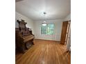 Dining room features refinished hardwood flooring, modern light fixture, and paneled doors at 3352 Northbrook Dr, Atlanta, GA 30340