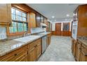 Spacious kitchen features granite countertops, wood cabinets, stainless steel appliances and access to back area at 3352 Northbrook Dr, Atlanta, GA 30340