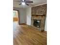 Living room featuring refinished hardwood flooring and a brick fireplace with wood mantle at 3352 Northbrook Dr, Atlanta, GA 30340