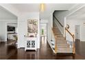 Elegant foyer with hardwood floors, a staircase, and views into adjacent rooms at 3977 Fox Glen Dr, Woodstock, GA 30189