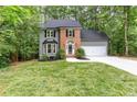 Inviting two-story home with gray siding, brick detail, and a lush green lawn at 4806 Deer Chase, Powder Springs, GA 30127