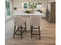 Modern kitchen with stainless steel appliances, white cabinetry, and a large island with seating at 4806 Deer Chase, Powder Springs, GA 30127