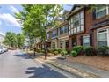 Row of townhouses with manicured front yards and street parking, perfect for suburban living at 529 Ridge View Crossing Xing, Woodstock, GA 30188