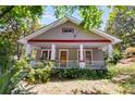 Charming home exterior featuring a covered front porch, and mature trees at 1405 May Se Ave, Atlanta, GA 30316