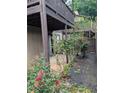 Exterior shot of yard with rose bushes, hardscape, and multi-level wooden decks at 206 River Run Dr, Atlanta, GA 30350