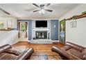 Cozy living room with a brick fireplace, wood floors, and decor, creating a warm and inviting atmosphere at 265 Tamea Trl, Covington, GA 30014