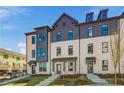 Stylish townhome shows a brick facade, multi-pane windows, and a neatly landscaped front yard on a sunny day at 445 Breccia Run, Mcdonough, GA 30253