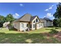 Expansive backyard featuring a well-manicured lawn and large windows with natural light at 6772 Blantyre Boulevard Blvd, Stone Mountain, GA 30087