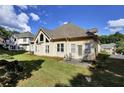 Spacious backyard with a well-maintained lawn and patio seating area at 6772 Blantyre Boulevard Blvd, Stone Mountain, GA 30087