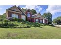 Attractive two-story home with manicured lawn, lush shrubbery, and traditional architecture at 6772 Blantyre Boulevard Blvd, Stone Mountain, GA 30087