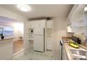 Cozy kitchen featuring built-in cabinets, sleek appliances, and patterned flooring at 819 Durant Ne # 819-6, Atlanta, GA 30308