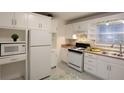 Bright kitchen featuring white cabinets, modern appliances, and patterned flooring at 819 Durant Ne # 819-6, Atlanta, GA 30308