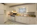 Bright kitchen with white cabinets, stainless steel sink, and patterned backsplash at 819 Durant Ne # 819-6, Atlanta, GA 30308