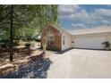 A home featuring an attached garage, brick accents, and manicured landscaping at 2191 Rockbridge Rd # 103, Stone Mountain, GA 30087