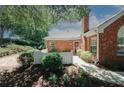 Brick home featuring manicured landscaping, a chimney, and a decorative front door wreath at 2191 Rockbridge Rd # 103, Stone Mountain, GA 30087