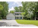 Beautiful two-story home boasts a lush front lawn and a classic design with a two-car garage at 3707 Dunwoody Club Dr, Atlanta, GA 30350