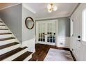 Inviting foyer boasts hardwood floors, staircase, fresh paint and stylish lighting fixture at 3707 Dunwoody Club Dr, Atlanta, GA 30350