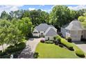 An aerial view of a well-maintained home with manicured landscaping and mature trees in a suburban neighborhood at 5120 Falcon Chase Ln, Atlanta, GA 30342