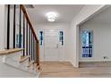 Open foyer with wood-look floors, white walls, and stairs with black iron railings at 315 N Fayette Dr, Fayetteville, GA 30214