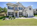 Beautiful two-story home with a manicured lawn, a two-car garage, and a classic brick facade at 383 Crestbrook Ln, Dallas, GA 30157