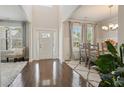 Bright foyer with soaring ceilings, hardwood floors, a large window and dining area adjacent to the entrance at 383 Crestbrook Ln, Dallas, GA 30157