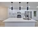 Bright kitchen features quartz countertops, a large island, stainless steel appliances and new cabinets at 450 Collier Ridge Nw Dr, Atlanta, GA 30318