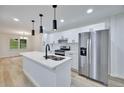 Bright kitchen features quartz countertops, a large island, stainless steel appliances and new cabinets at 450 Collier Ridge Nw Dr, Atlanta, GA 30318