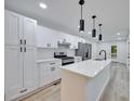 Bright kitchen features quartz countertops, a large island, stainless steel appliances and new cabinets at 450 Collier Ridge Nw Dr, Atlanta, GA 30318