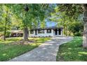 Inviting, one-story white brick home with a long driveway and lush green lawn at 1207 Ellington Dr, Morrow, GA 30260