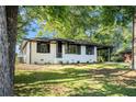 One-story white brick home with black trim, a carport, and well-manicured lawn at 1207 Ellington Dr, Morrow, GA 30260