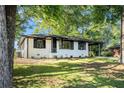 Charming single-story home with freshly painted facade, manicured lawn, and a carport on the right side at 1207 Ellington Dr, Morrow, GA 30260