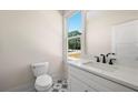 Stylish half-bathroom with modern fixtures, a marble countertop, and patterned tile flooring at 110 Hogue St, Atlanta, GA 30312