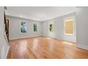 Bright living room featuring beautiful hardwood floors, large windows, and neutral paint, perfect for relaxation at 110 Hogue St, Atlanta, GA 30312
